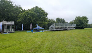 45-foot, 10-row towable bleacher by the disc golf basket (or target) at the 2026 DGPT Discmania Challenge at Pickard Park in Indianola, Iowa at Hole 18