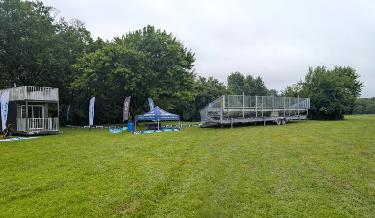 45-foot, 10-row towable bleacher by the disc golf basket (or target) at the 2026 DGPT Discmania Challenge at Pickard Park in Indianola, Iowa at Hole 18