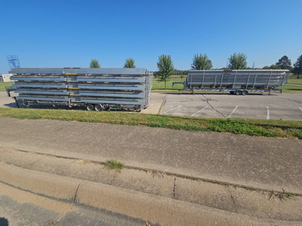 Big Ten Rentals 15-row 45-foot towable grandstand and 10-row 45-foot towable bleacher parked on campus at Emporia State University in Emporia, Kansas.
