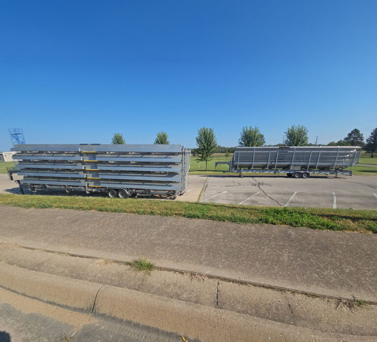 Big Ten Rentals 15-row 45-foot towable grandstand and 10-row 45-foot towable bleacher parked on campus at Emporia State University in Emporia, Kansas.