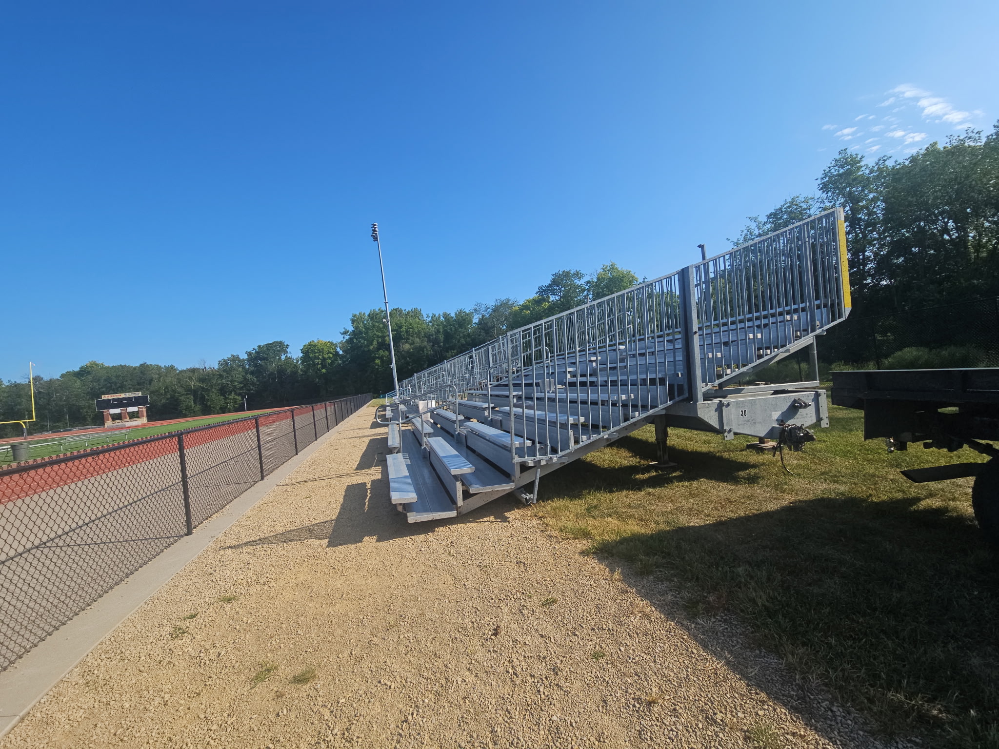Side view of the rented towable bleachers for a football game at Assumption High School & St. Ambrose University in Davenport, Iowa