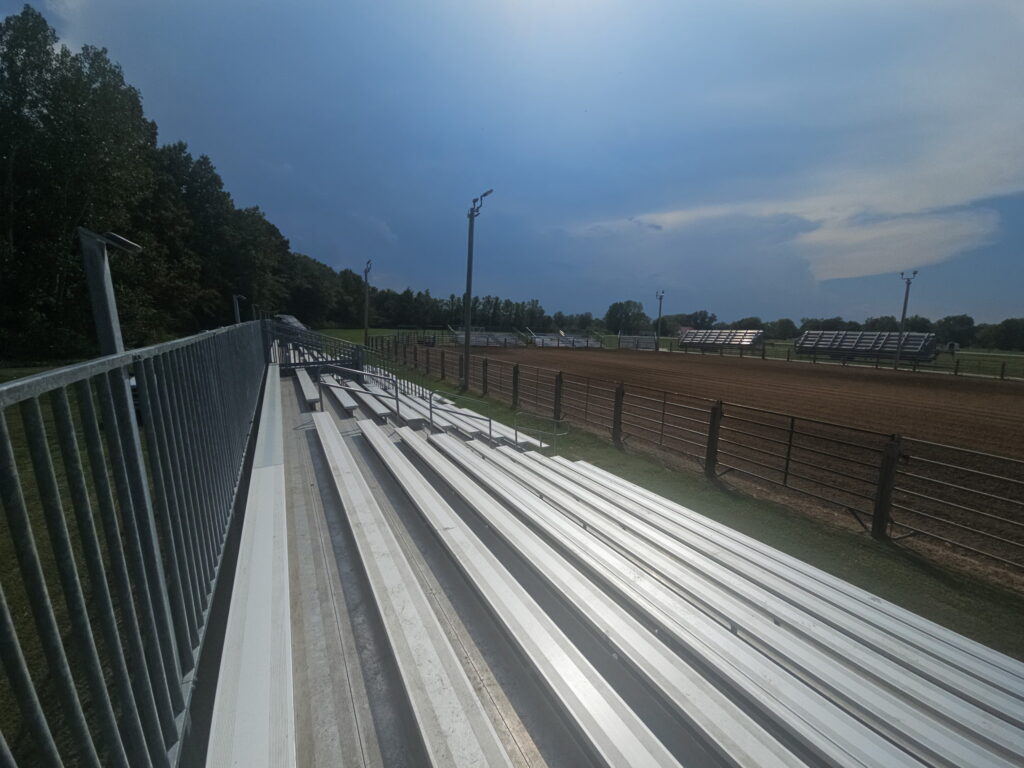 Spectator view down the rows of a 10-row towable bleacher at the Pacific Missouri Iron Horse Rodeo